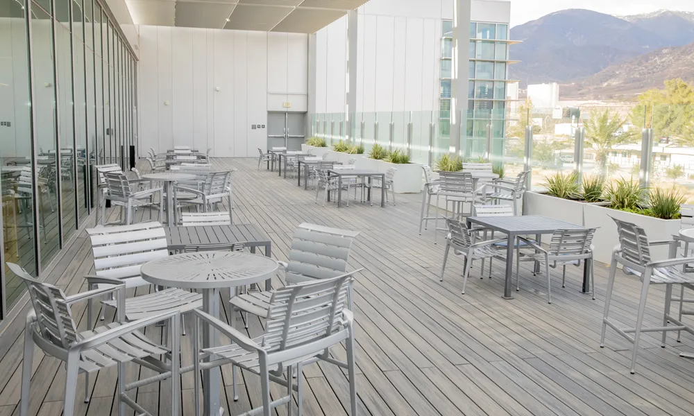 A stylish outdoor event space with sleek furniture, soft lighting, and an inviting atmosphere.