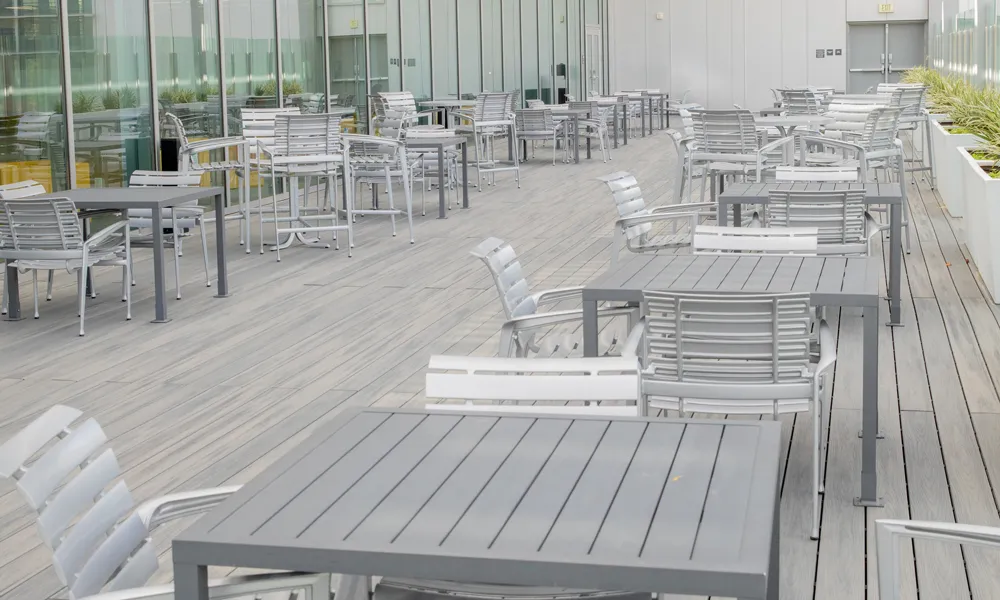 A side-angle view of an open-air terrace with comfortable seating, ideal for casual and formal gatherings.
