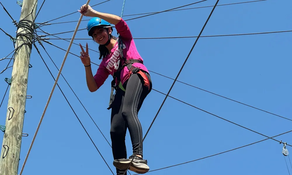 Student climbing ropes