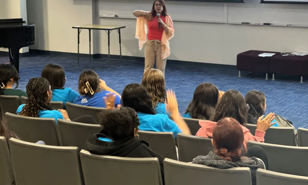 Presenter giving a workshop to group of students 