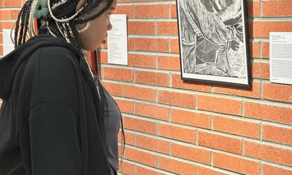 Student looking at a painting in a museum