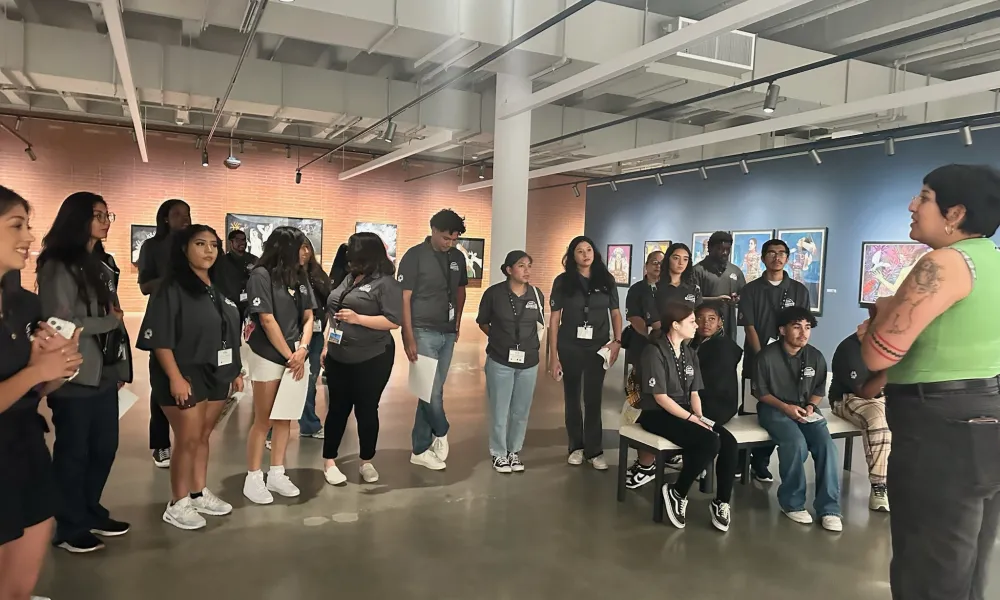 Group of students listening to a presentation by a museum guide
