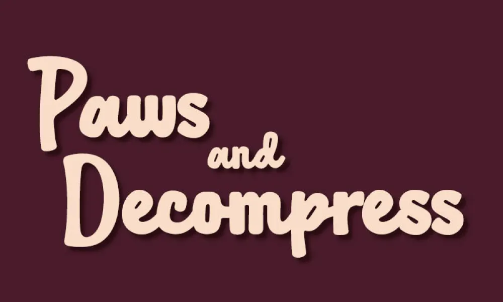 Graphic with “Paws and Decompress” in peach-cream script letters on a solid dark maroon background. “Paws” is at the top left, a small “and” sits in the middle, and “Decompress” is large on the bottom line.