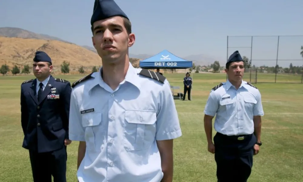 Student in uniform standing at attention 