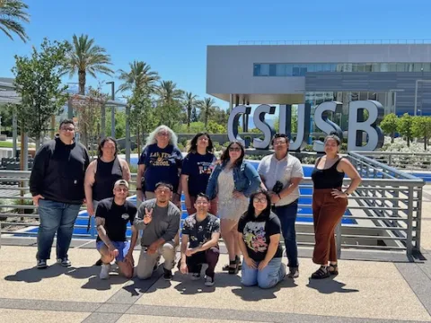 Editorial Staff, students in front of CSUSB sign