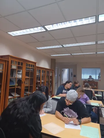 Students work in the archives at a desk
