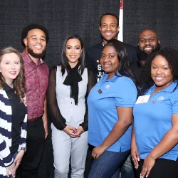 Angela Rye (center, wearing the black bow) with some of the staff from the CSUSB Office of Student Engagement
