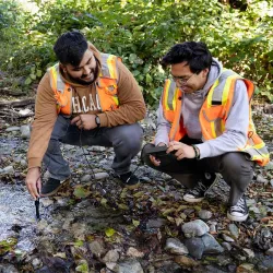 CSUSB students Alan Salcedo (left) and David Hernandez check water readings at Lytle Creek for their Geography Field Experience class. 