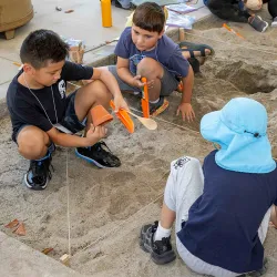 Children playing in a sand box during the 2024 Kids Discover Eygpt Workshop at CSUSB.