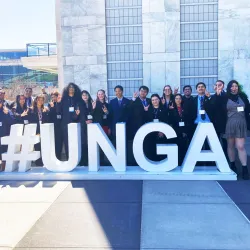 The CSUSB Model United Nations team at the United Nations in New York, standing behind the #UNGA sign.