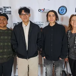 The students winning the silver ADDY Award are Isaac Abraham, Aaron Santos and Christopher Xavier. Picture with Coyote Radio & Advertising Operations Manager Kelli Cluque.