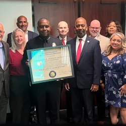 CSUSB Police Chief John Guttierez, surrounded by university administrators, holds a plaque from the International Association of Campus Law Enforcement Administrators that officially recognizes that the University Police Department has been accredited.