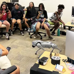Students in the Verizon Innovative Learning Summer Camp watch a demonstration of a robot dog at the xREAL Lab at CSUSB. 