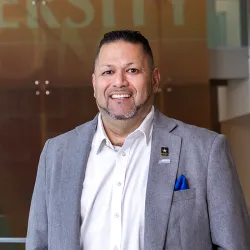 CSUSB alumnus RalphFigueroa, a rehabilitation counseling graduate, U.S. Army veteran and first-generation college graduate, on the Cal State San Bernardino campus.