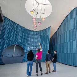 Professor Katherine Gray, second from left, and the three students who helped her create and install the chandelier, admire their handwork.