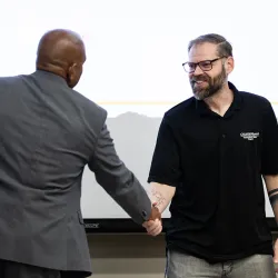 Provost Rafik Mohamed, left, presented the 2025-26 Golden Apple Award to Nathaniel Bodell, associate professor of kinesiology.