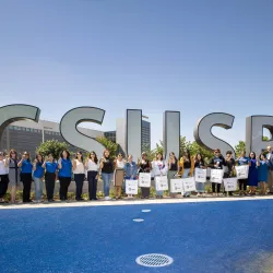 Group of people in front of the CSUSB spirit letters.