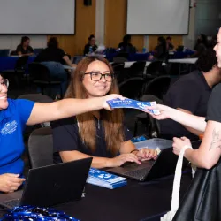 Photo of CSUSB admission counselors and a student. CSUSB in August held an Instant Admit Day at San Bernardino Valley College. NOTE: Photo was AI-enhanced (background edges) to fit the dimensions on this webpage.