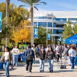 Students make their way along Coyote Walk at CSUSB. 