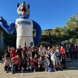 Students in front of an inflatable Cody Coyote.