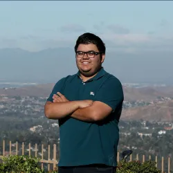 Mark Araujo-Levinson smiling with arms crossed