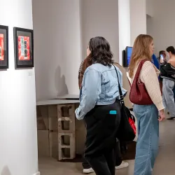 Attendees study the artwork displayed at the Feb. 8 reception for the “Echoes of Identity” exhibit at the Robert and Frances Fullerton Museum of Art.