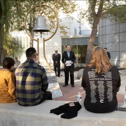 William Vandyke (center), a CSUSB health science and human ecology faculty member, speaks at the annual Day of Remembrance ceremony at CSUSB on Dec. 2, 2023.