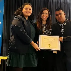 Bibiana Diaz and two others hold up their award