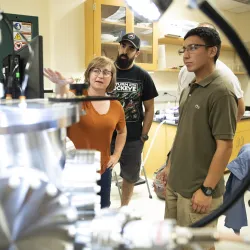 Sara Callori, assistant professor of physics, works with students in a CSUSB lab.