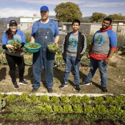 From left, Kristen Stutz, director of the Student Assistance in Learning (SAIL) program at CSUSB; student Sandra Garcia; contract farmer Kevin Head; student CJ Silvestre; and Terrence McCullough, at the Anne Shirrells Community Garden during the 2023 Coyote Cares Day at the Akoma Unity Center in San Bernardino.