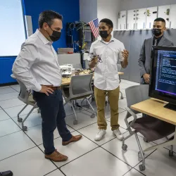 Congressman Pete Aguilar (left) and students at the CSUSB Cybersecurity Center.