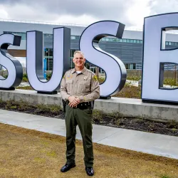 Shannon Dicus in front of the CSUSB letters