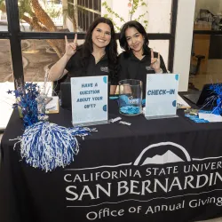 Two students at the sign-in desk for the event.