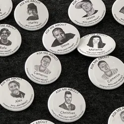 Buttons displaying the portraits of those lost to substance use disorder at the INTO LIGHT exhibit at the CSUSB Anthropology Museum.