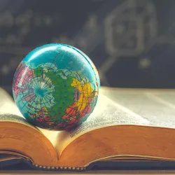 Small globe on an open book.