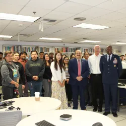 Beginning at center left, Jennifer Jin (in the white jacket), assistant professor, School of Computer Science and Engineering; Khalil Dajani, director and professor, School of Computer Science and Engineering; Stephan Ewart, U.S. Air Force Head of Engineering Squadron; Air Force Col. Ahave Brown Jr., commander of 412 MXG Squadron; with students who attended an Oct. 26 event at CSUSB.