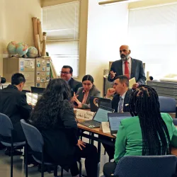 Sina Bastami (standing), director of the CSUSB Model UN program, gives student delegates some pointers as they prepared for the National United Nations Conference, which takes place in New York City April 10-14.