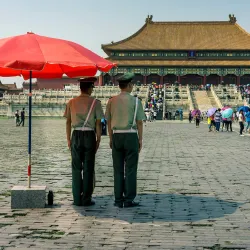 Police officers watch over visitors to the Forbidden City in Beijing, China.