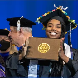 Photo of a graduate celebrating