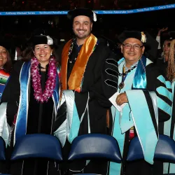 CSUSB graduates smiling at the 2019 commencement at the Toyota Arena
