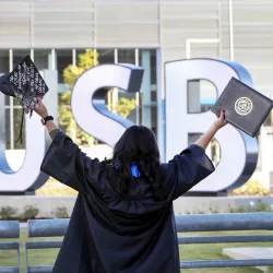Student at the CSUSB sign by SMSU North