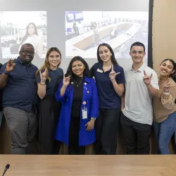 CSU Student Trustee Diana Aguilar-Cruz, center, in blue coat, shares some Coyote Pride with CSUSB ASI officers.