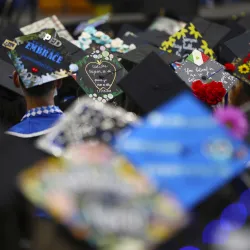 Graduates express their accomplishments on their mortar boards.