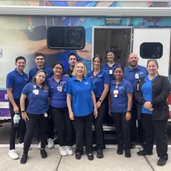 Members of the CSUSB Nursing Street Medicine Program pose in front of a new mobile medical clinic at the unveiling and ribbon-cutting ceremony in Palm Springs, Calif. on Dec. 2. From L to R: Danny Castaneda, Veronica Cretsinger, Sayaff Eid, Jessica Rodriguez, Alexis Molina Gonzalez, Diane Vines, Sarah Harrington, Julie Suriano, Nallely Herrera, Matthew Morse, Catherine Lievanos. 
