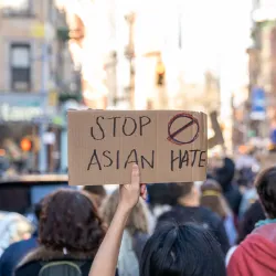 A sign held up at a rally protesting anti-Asian hate. 