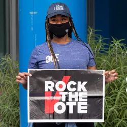 CSUSB student holding the Rock the vote sign
