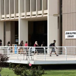 Students at the Pfau Library entrance