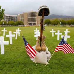Rifle, helmet, boots, flags and crosses from a Memorial Day event on campus, file photo.