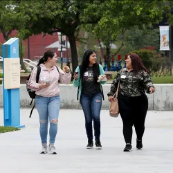 Three students walking on campus