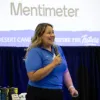 Palm Desert Campus team presenter speaking during the Process Improvement & Lean Operations (PILOT) Year-End Showcase, presenting the team's project on improving student enrollment through enhanced engagement and support services.